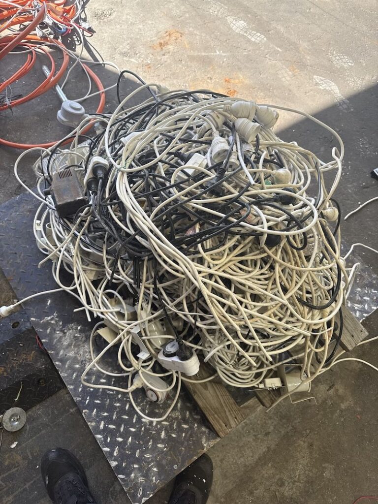 Tangled household power cables and powerboards dropped off for scrap copper recycling in Perth